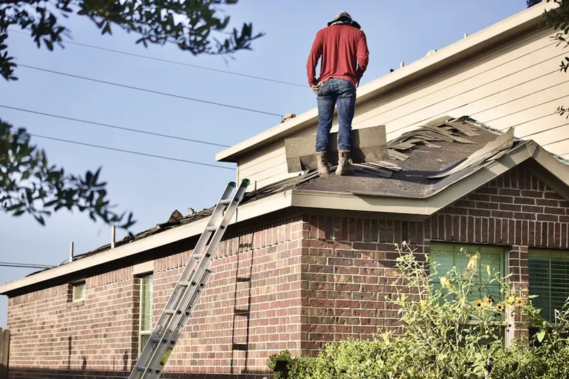 Professional roofer working on a residential roof in Fremd Village